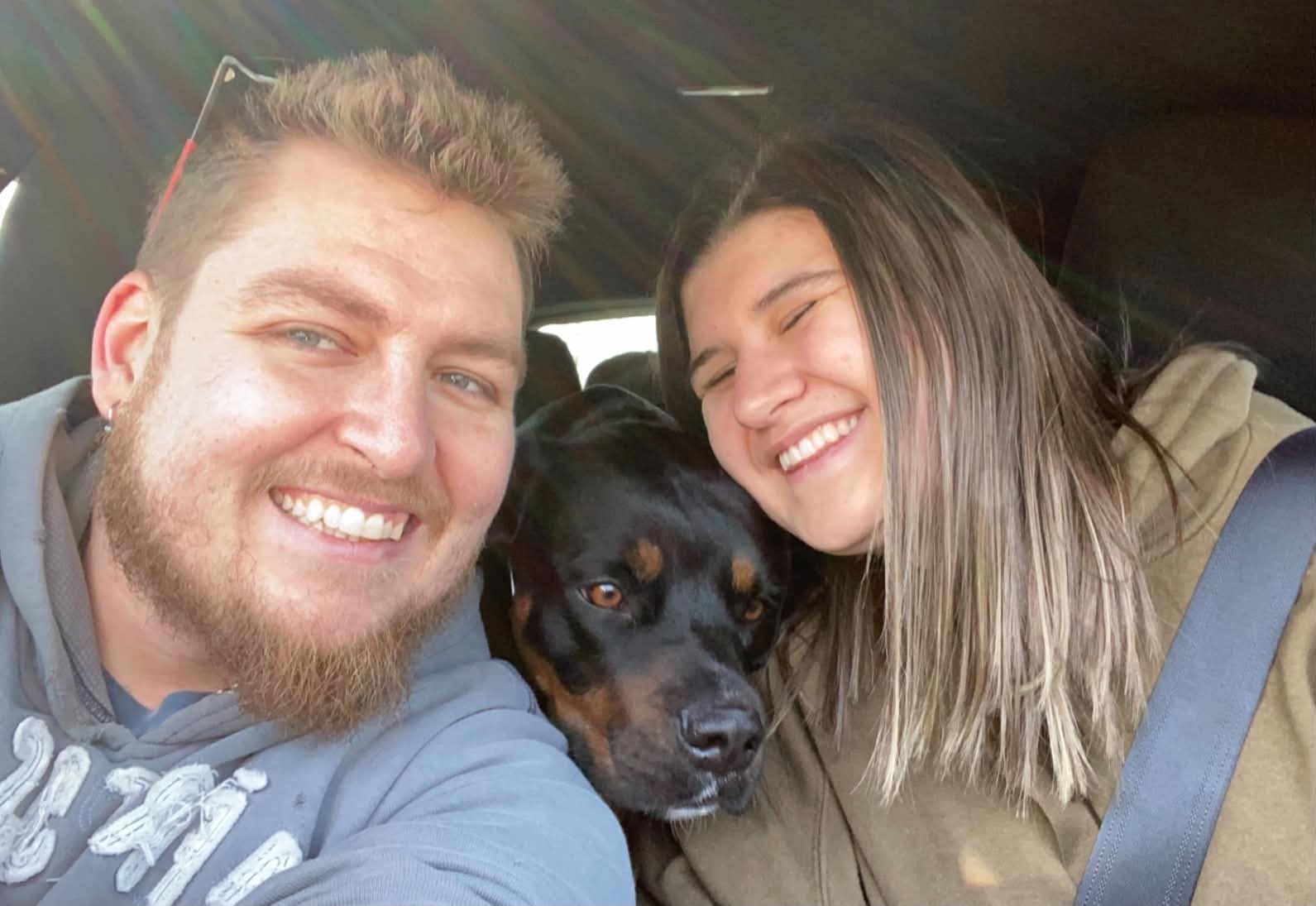 JB and Alexis posing for a photo with their dog Letty.
